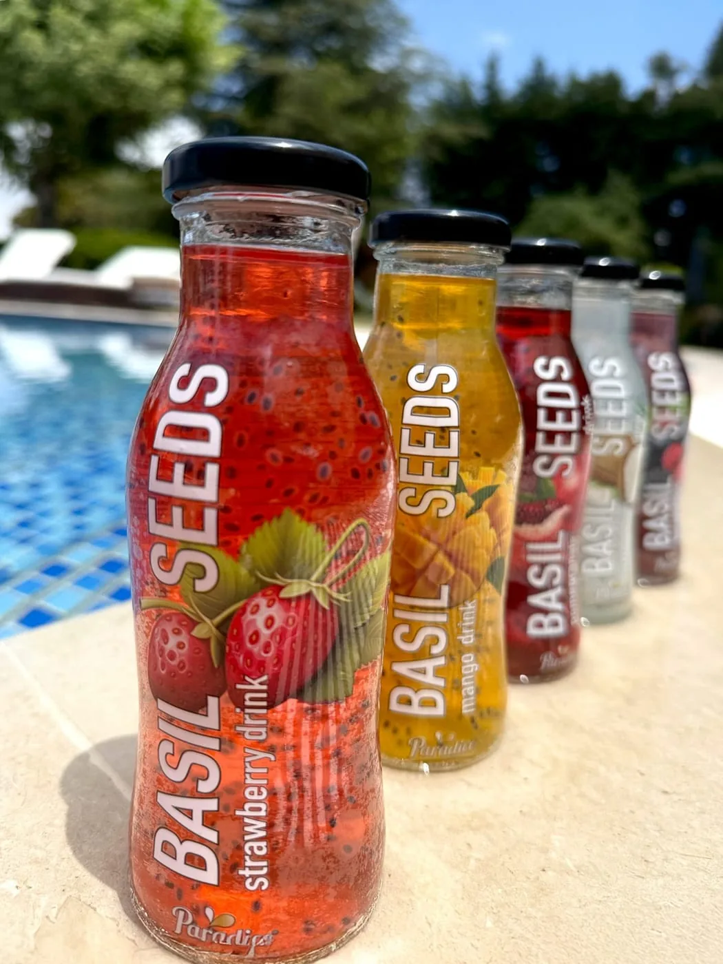 Paradice Basil Seeds bottles by the pool — flagship drink by Stork SAL